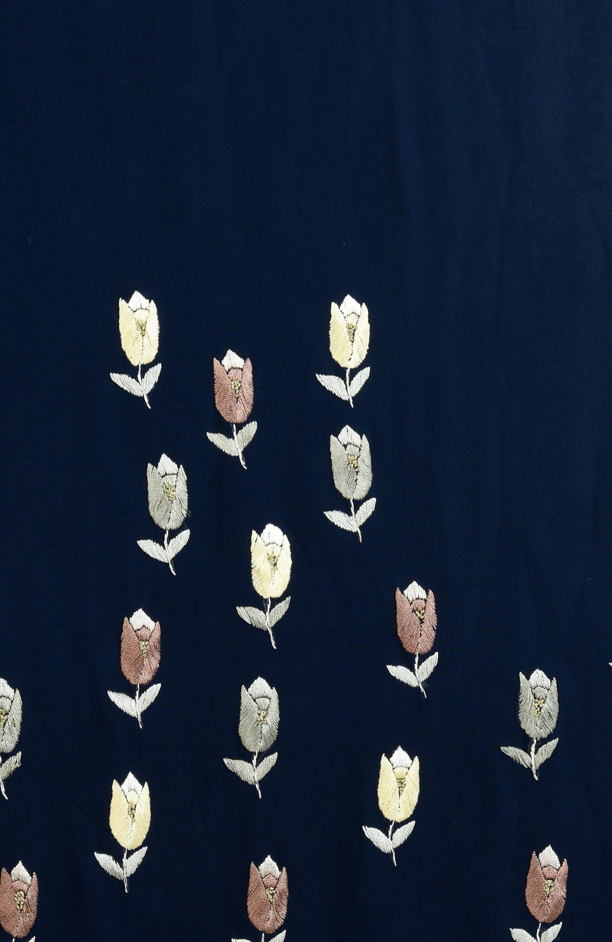 Midnight blue saree with hand-embroidered floral patterns in gold, brown, and white.