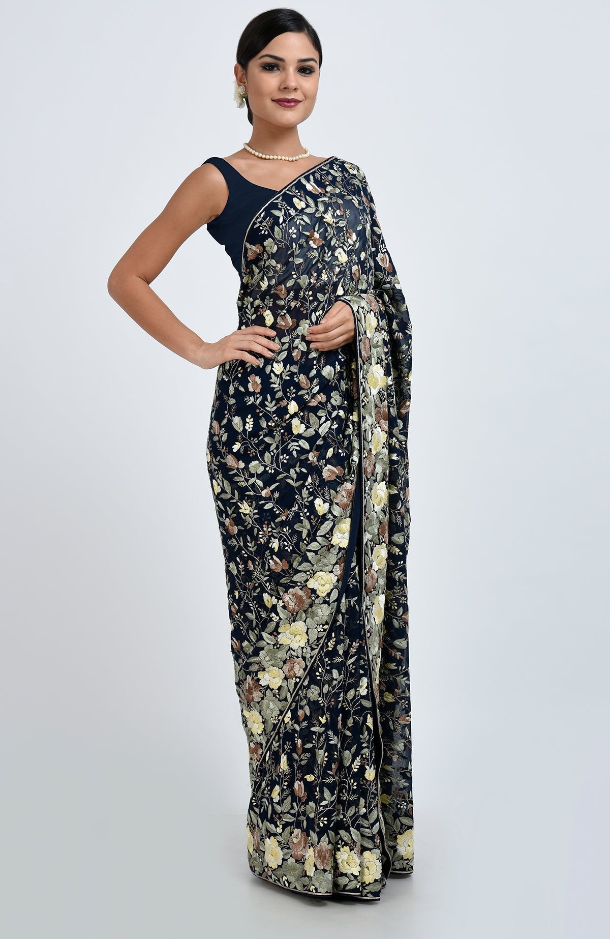 Woman in a midnight blue Parsi Gara hand-embroidered saree with floral patterns.