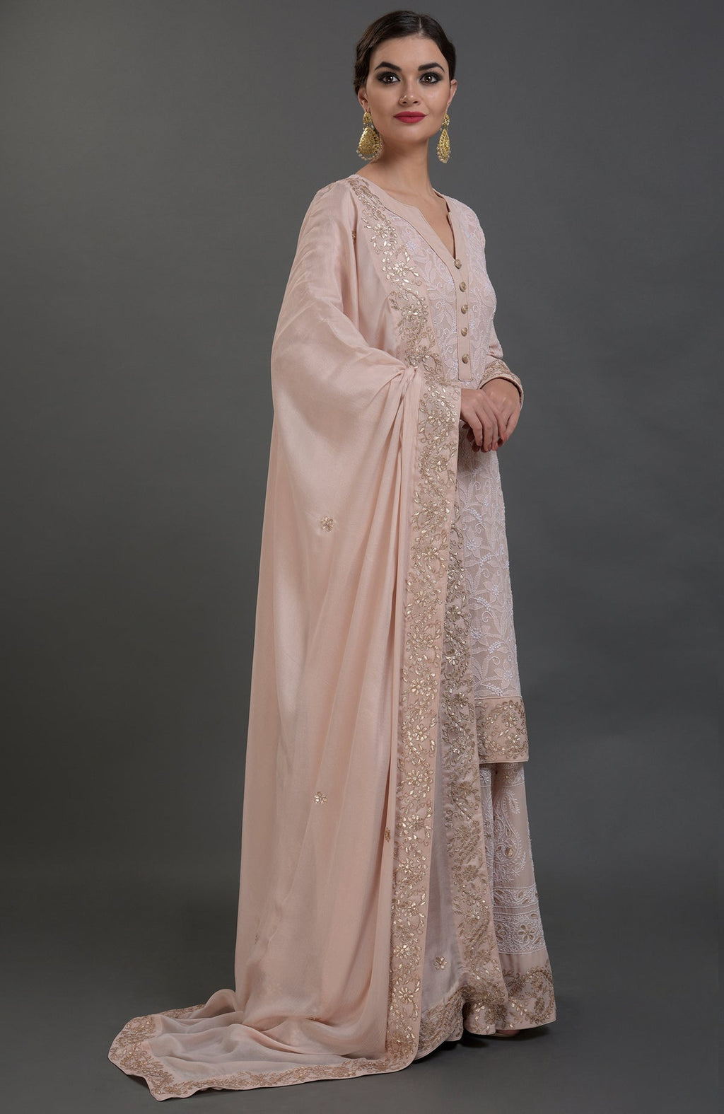 Oyster pink Chikankari and Gota Patti hand embroidered sharara suit.