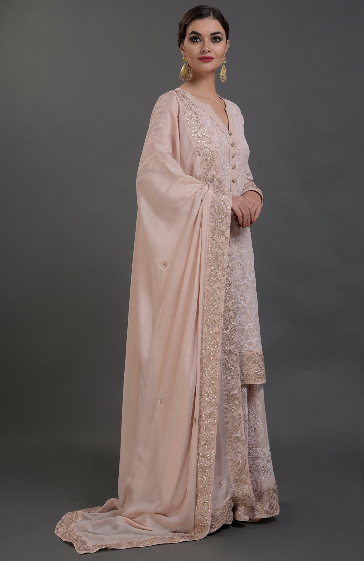 Oyster pink Chikankari and Gota Patti hand embroidered sharara suit.