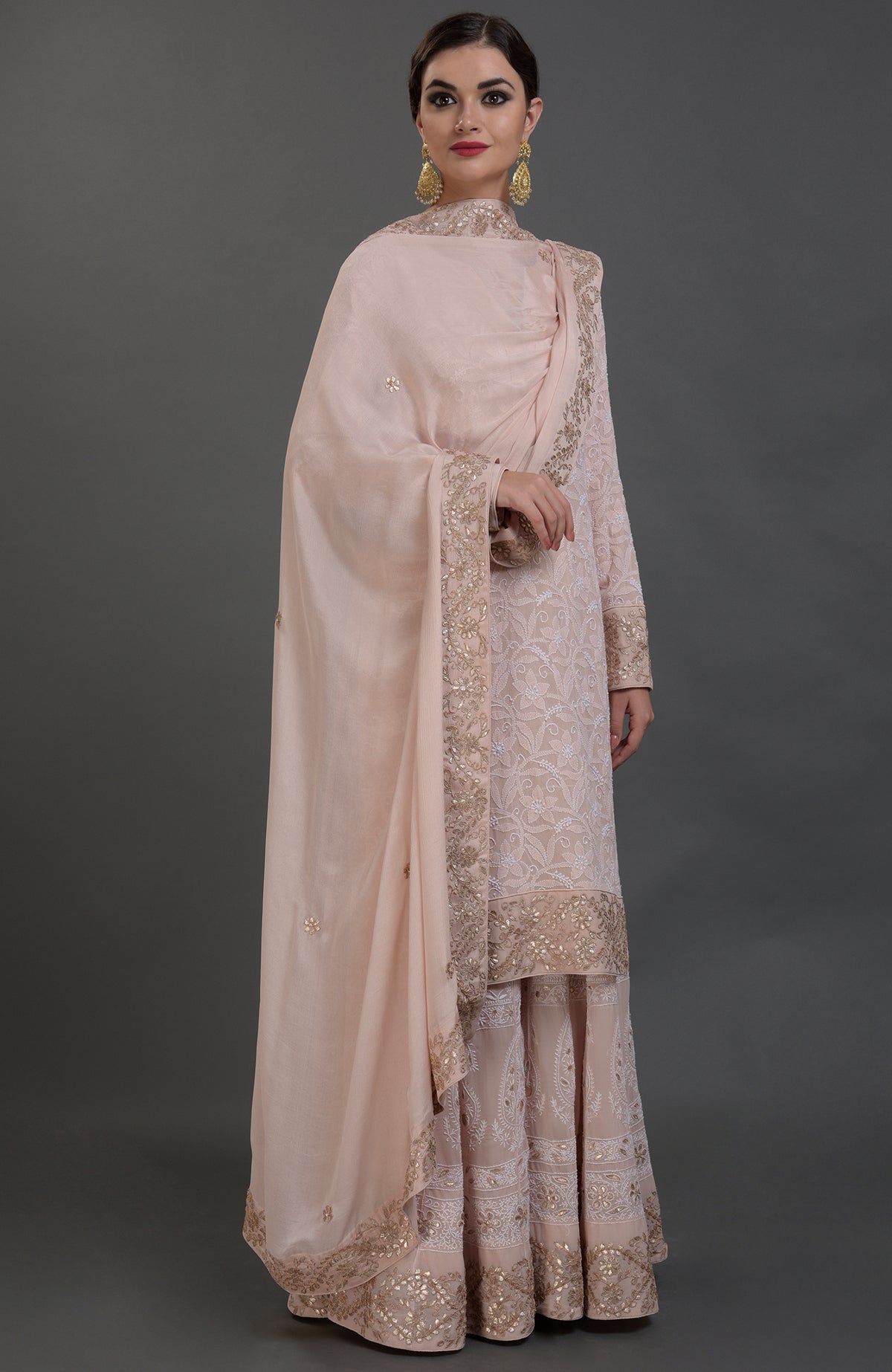 Oyster pink Chikankari and Gota Patti hand embroidered sharara suit.