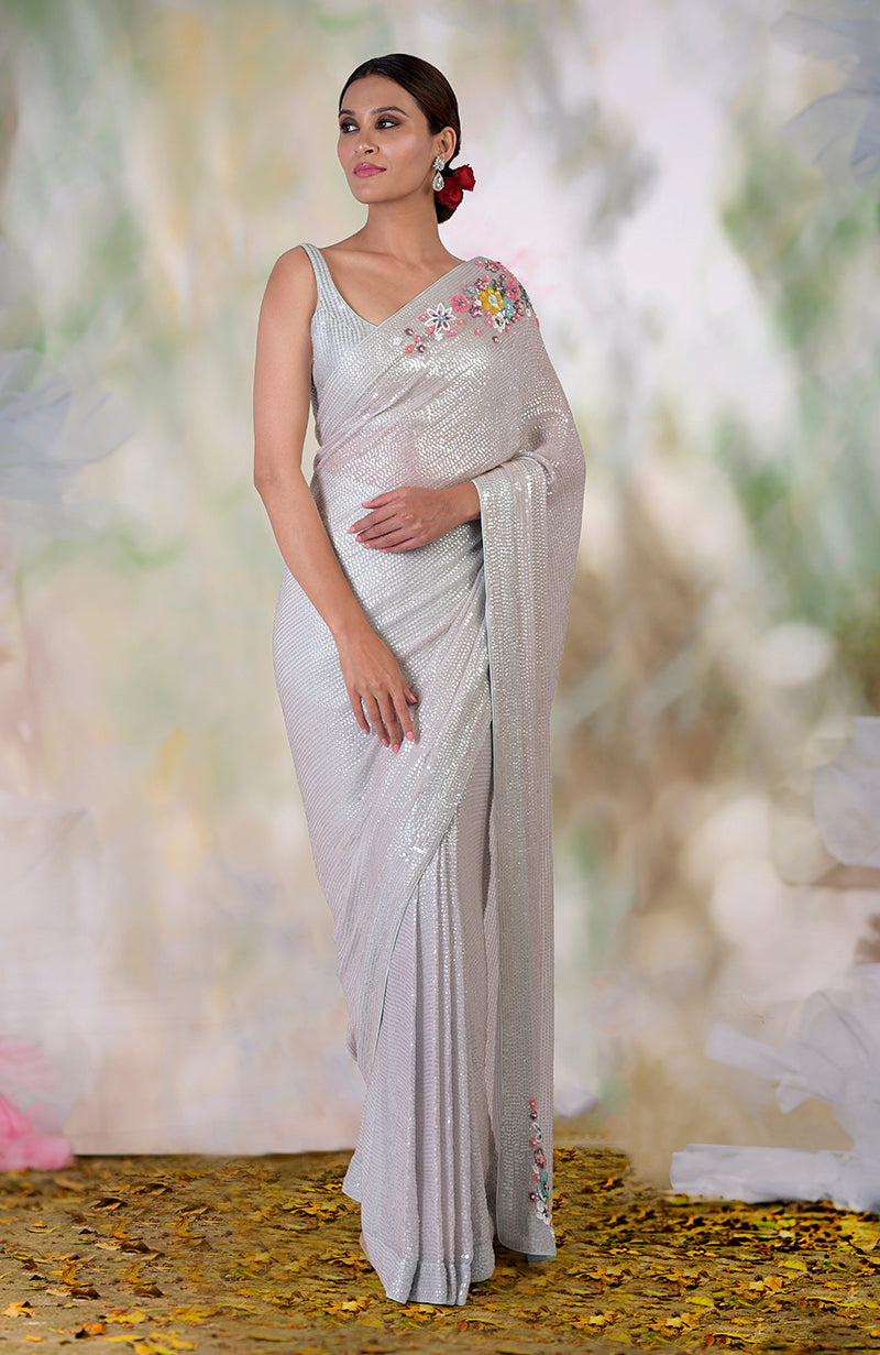 Whispering blue sequin saree with floral hand embroidery on the shoulder and hem.