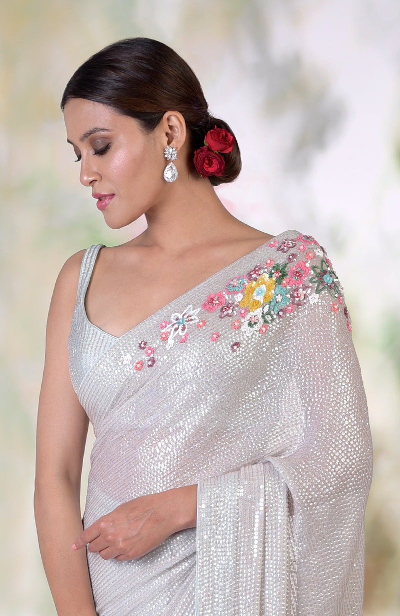 Whispering blue floral sequin hand embroidered saree with a matching blouse.
