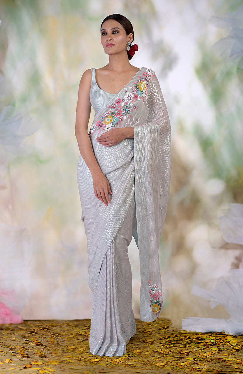 Whispering blue floral sequin hand embroidered saree with a matching blouse.