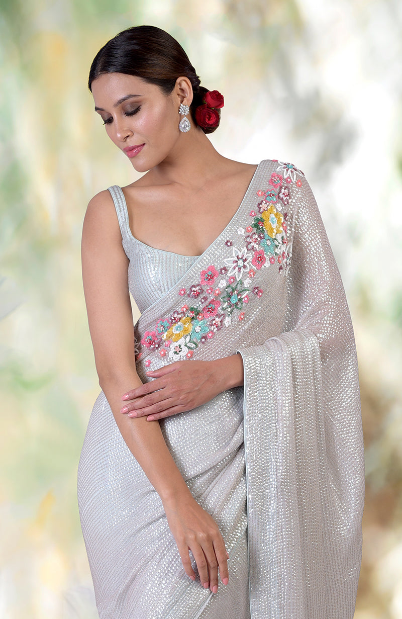 Whispering blue floral sequin hand embroidered saree with a matching blouse.