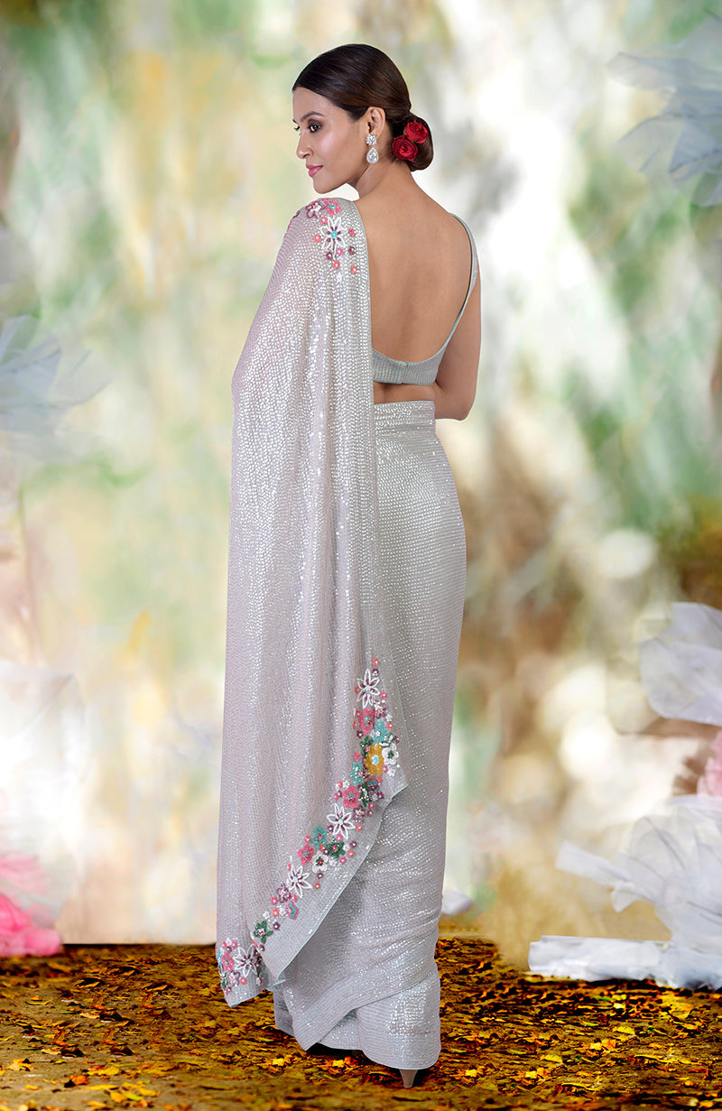 Whispering blue floral sequin hand embroidered saree with a matching blouse.
