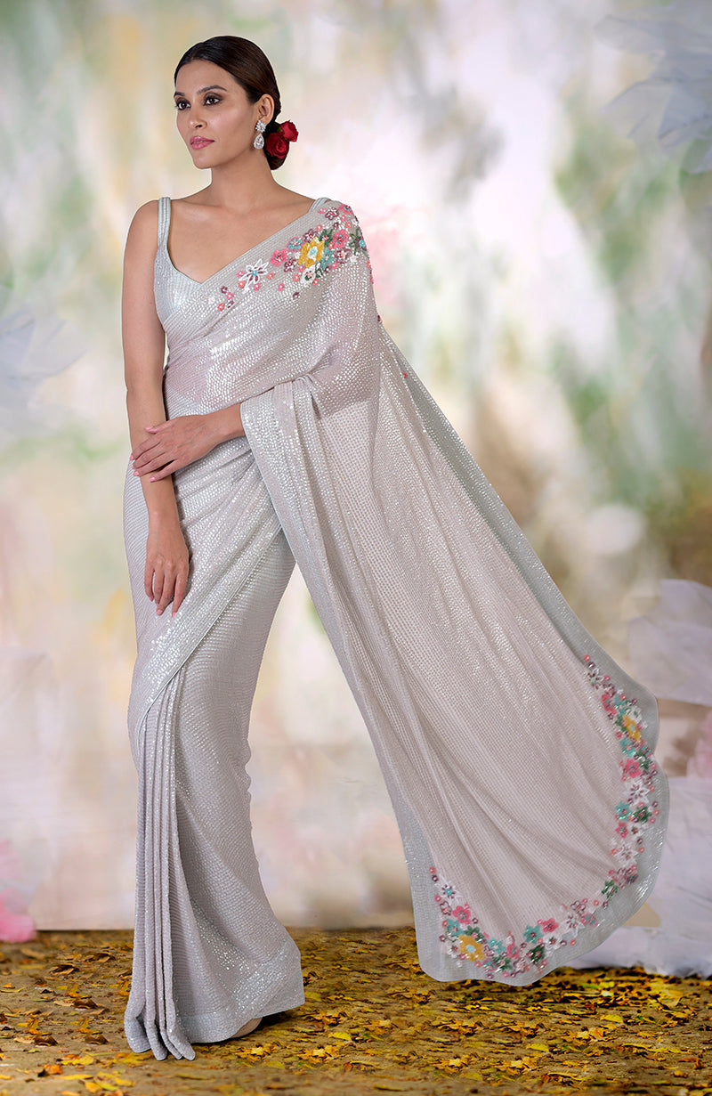 Whispering blue floral sequin hand embroidered saree with a matching blouse.