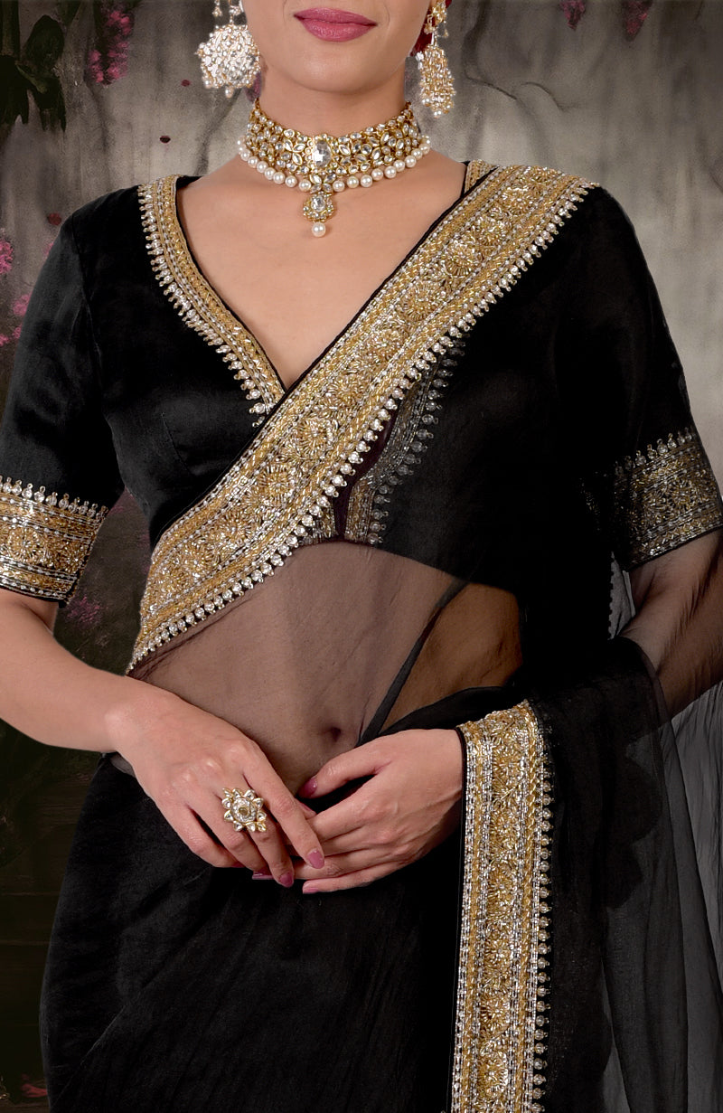 Black saree with gold and silver zardozi embroidery, paired with a matching blouse.