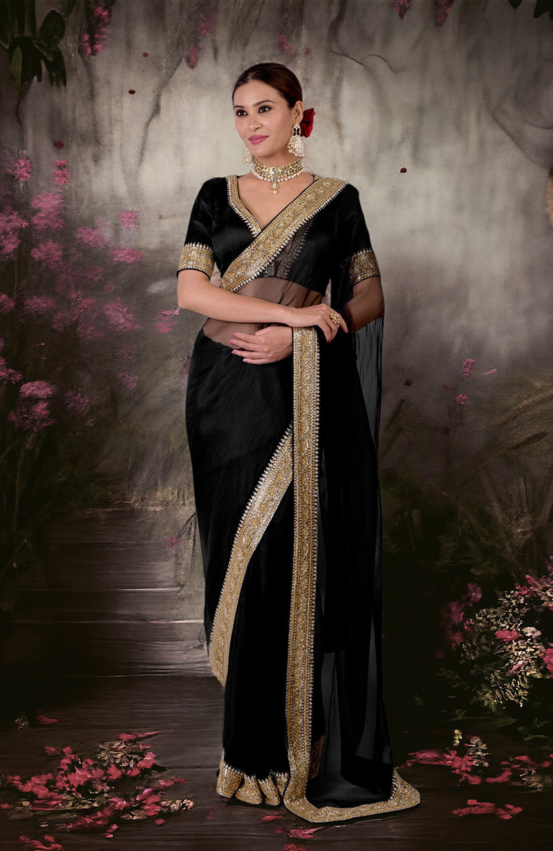 Black saree with gold and silver zardozi embroidery and a matching blouse.