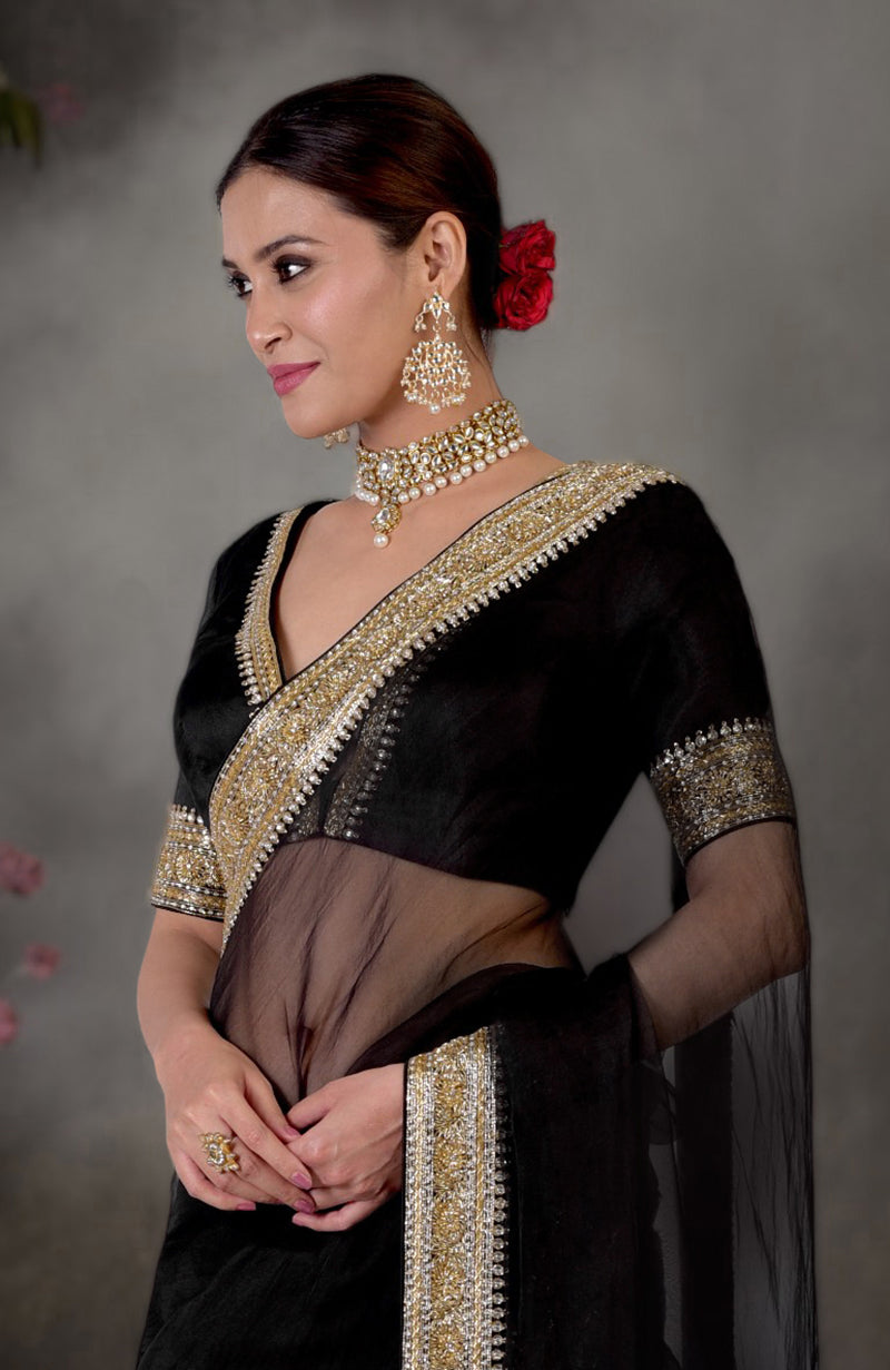 Black saree with gold and silver zardozi embroidery, paired with a matching blouse.