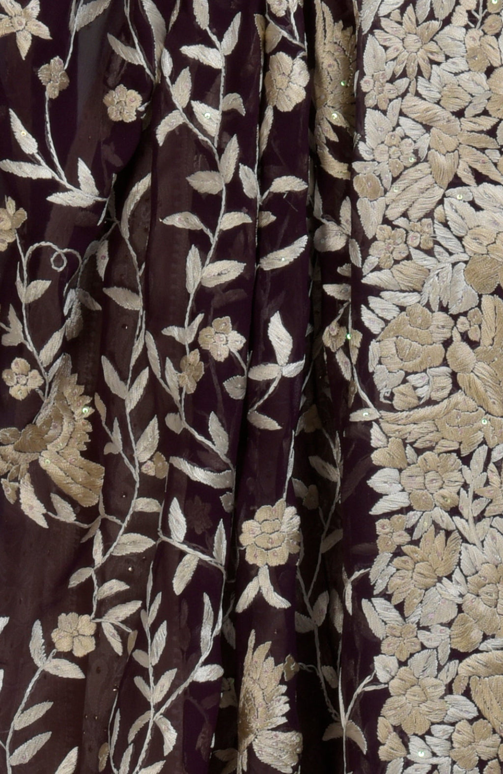 A dark purple fabric with champagne floral embroidery and sequin embellishments.