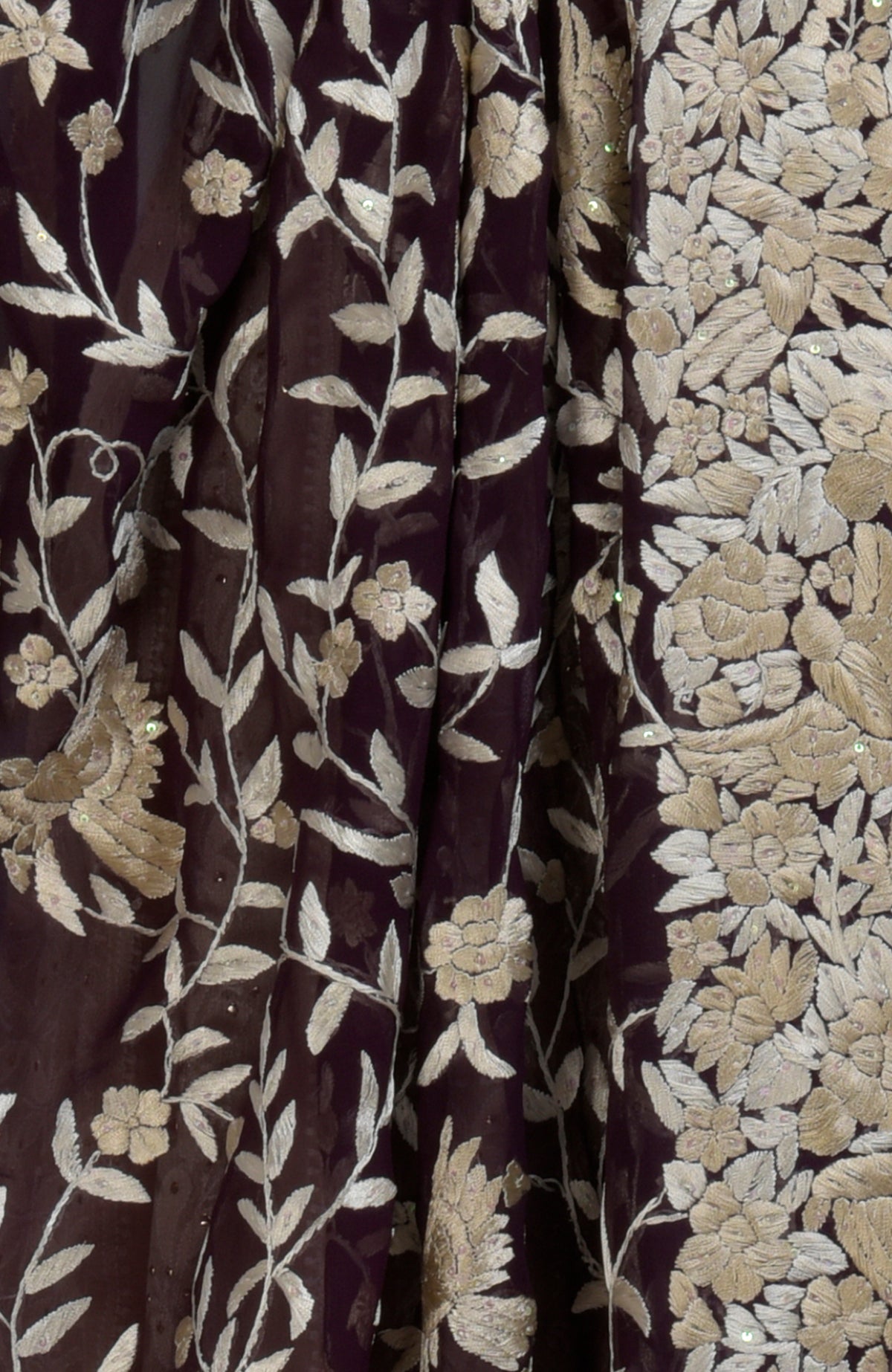 A dark purple fabric with champagne floral embroidery and sequin embellishments.