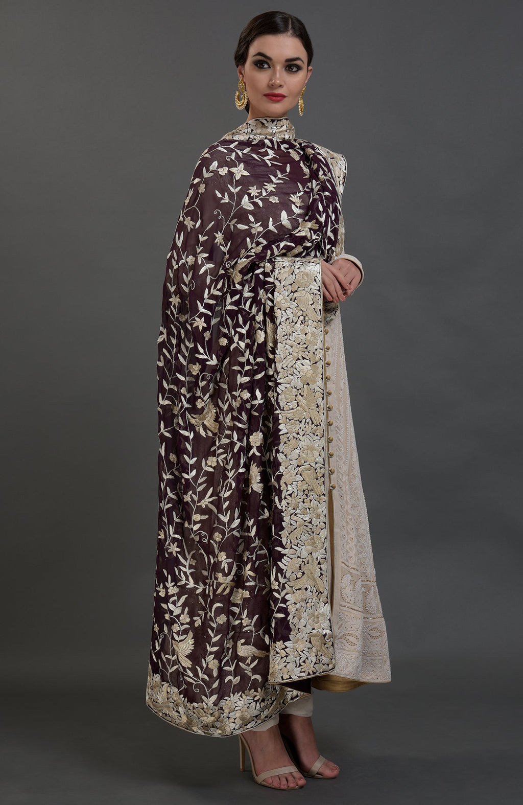 A model wears a champagne chikankari suit with a parsi gara hand-embroidered dupatta.