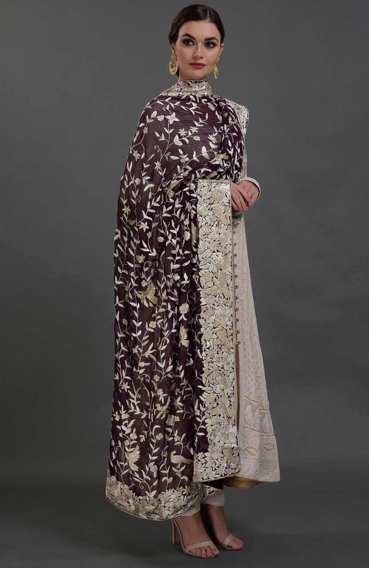 A woman models a champagne chikankari suit with a Parsi Gara hand-embroidered dupatta.