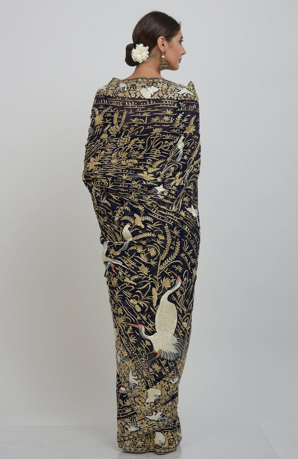 Midnight blue Parsi Gara hand-embroidered saree with floral and crane-bird motifs.