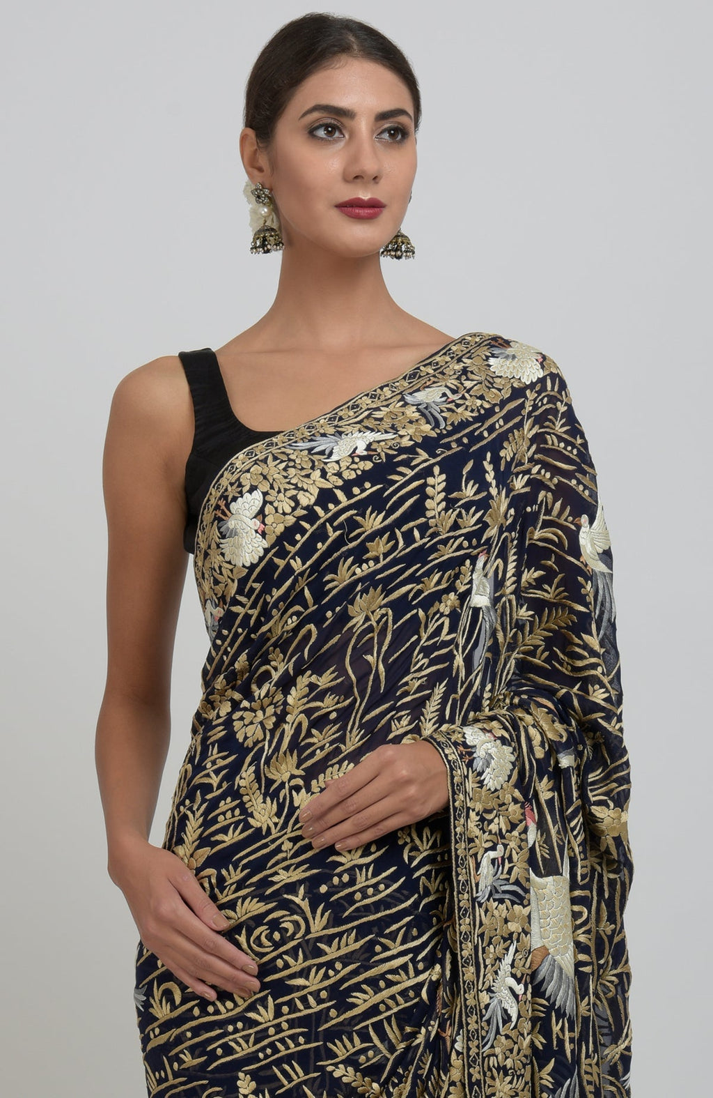 Midnight blue Parsi Gara hand-embroidered saree with floral and bird motifs.