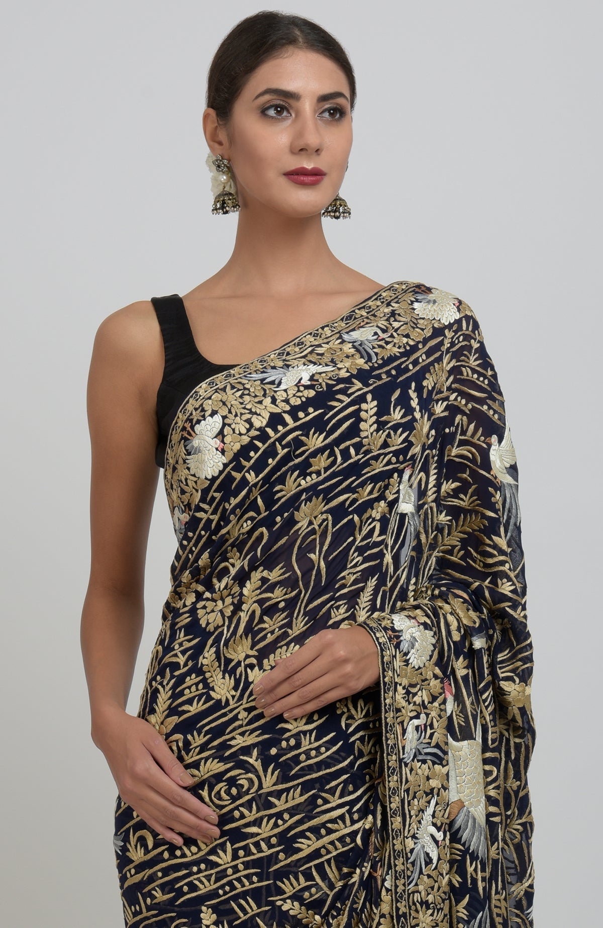 Midnight blue Parsi Gara hand-embroidered saree with floral and bird motifs.