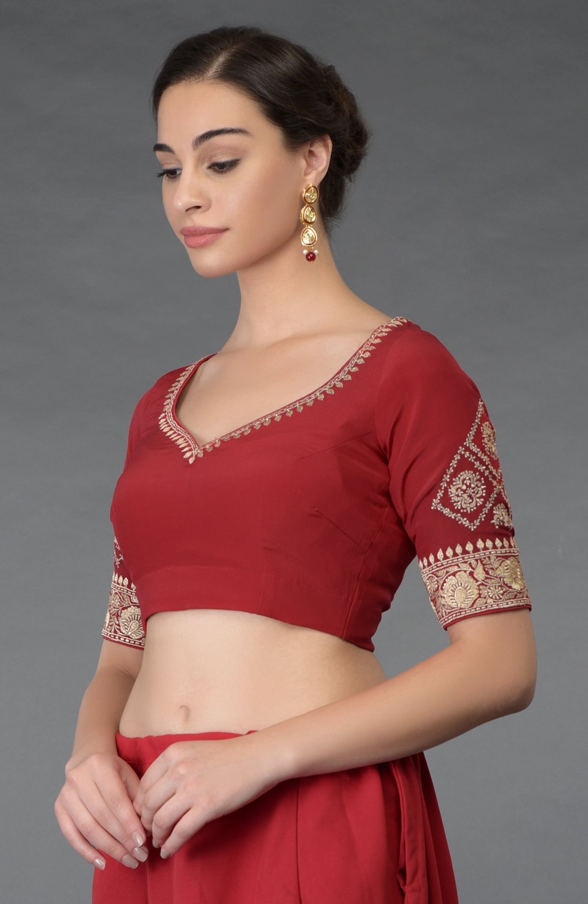 Red gold tilla embroidered blouse with a V-neck and elbow-length sleeves.