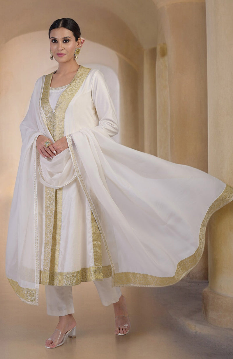 An elegant woman models an ivory and gold Banarasi handwoven overlay set.