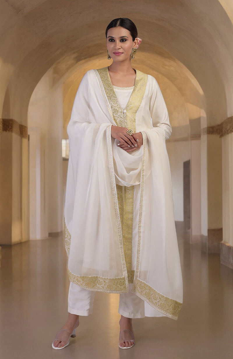An elegant woman models an ivory and gold Banarasi handwoven overlay set.