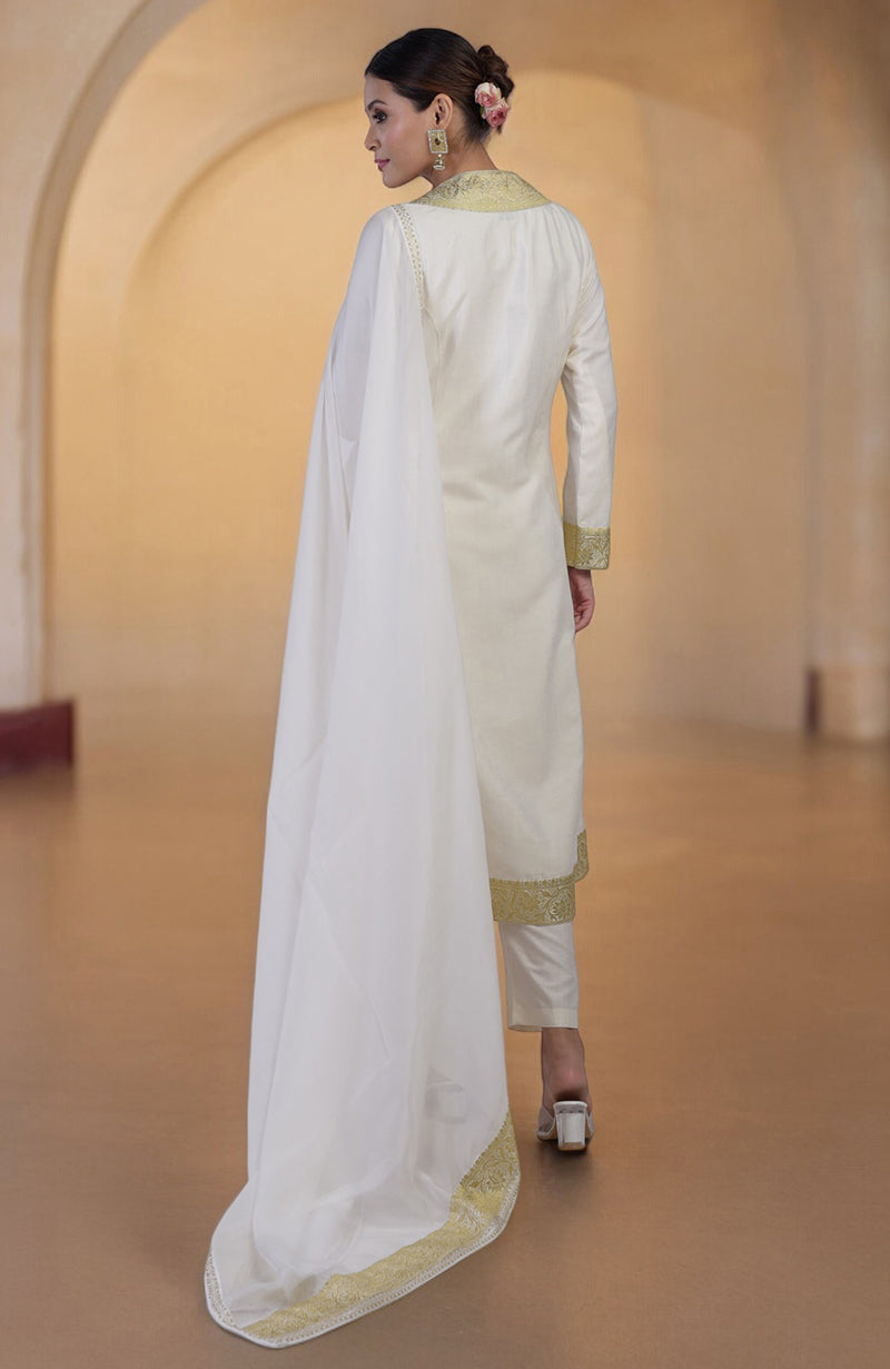 A woman in an ivory and gold Banarasi handwoven overlay set with a matching dupatta.