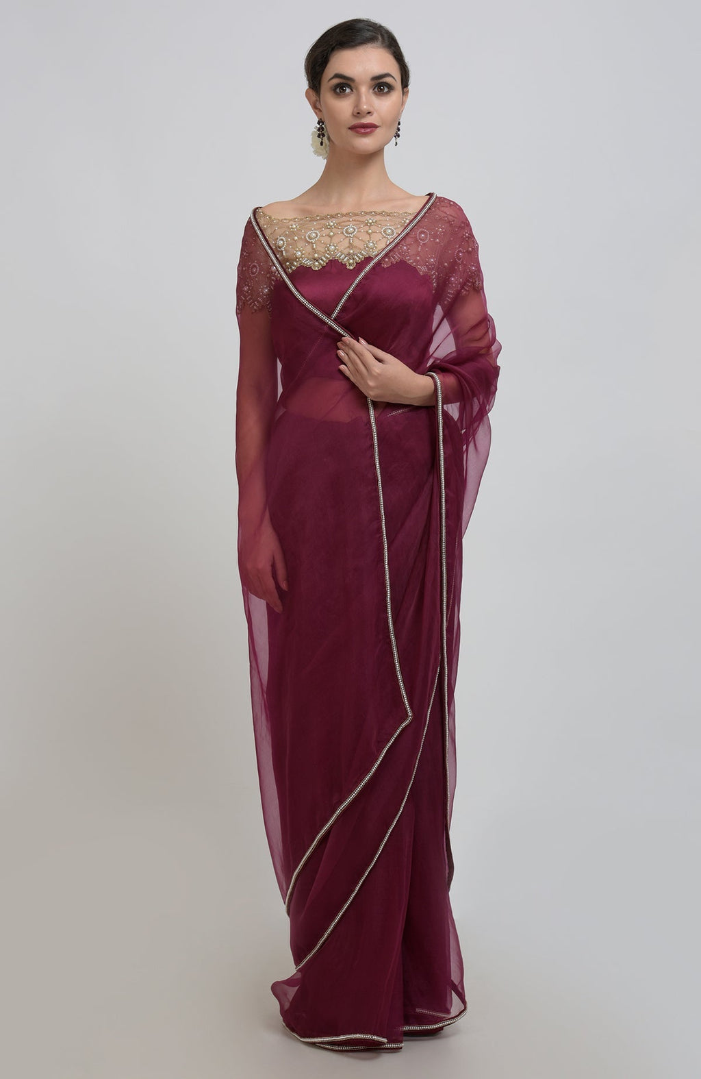 Burgundy organza silk saree with pearl bead embroidery and a matching blouse.