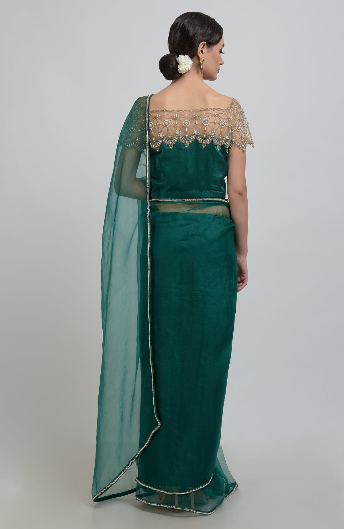 Emerald green saree with pearl bead embroidery on the blouse and borders.