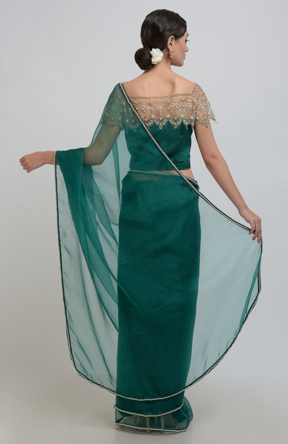 Emerald green saree with a pearl-beaded blouse and sheer dupatta.