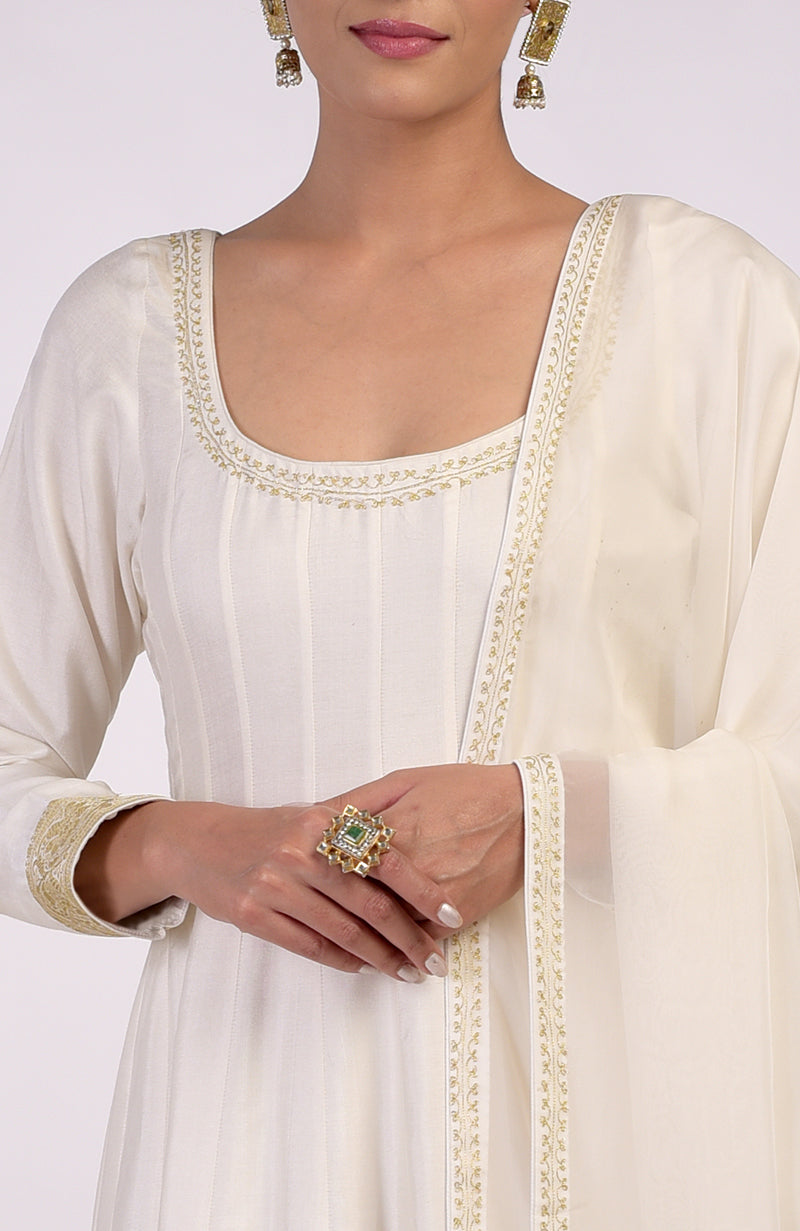 Ivory gold Banarasi handwoven Anarkali set with a ring and earrings.