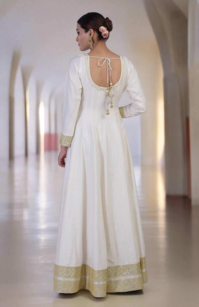 An ivory and gold Banarasi handwoven Anarkali set with a scoop neckline.