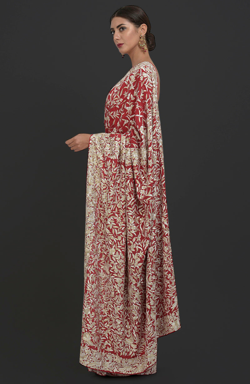Red Parsi Gara hand-embroidered saree with floral and bird patterns.