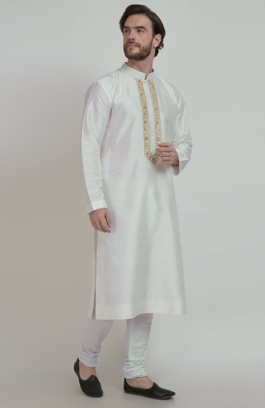 Ivory silk kurta with gold tilla embroidered placket, paired with white churidar and black shoes.