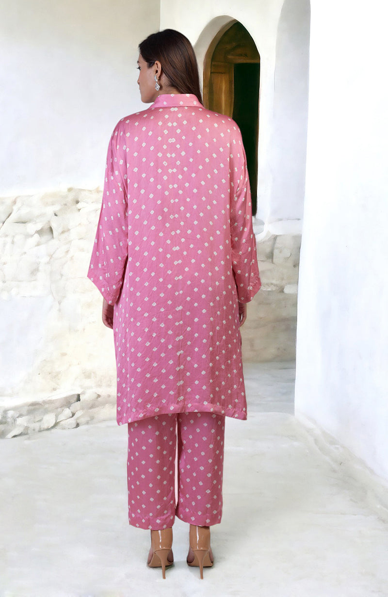 A woman from behind wears a pink bandhej embroidered co-ord set with matching pants.
