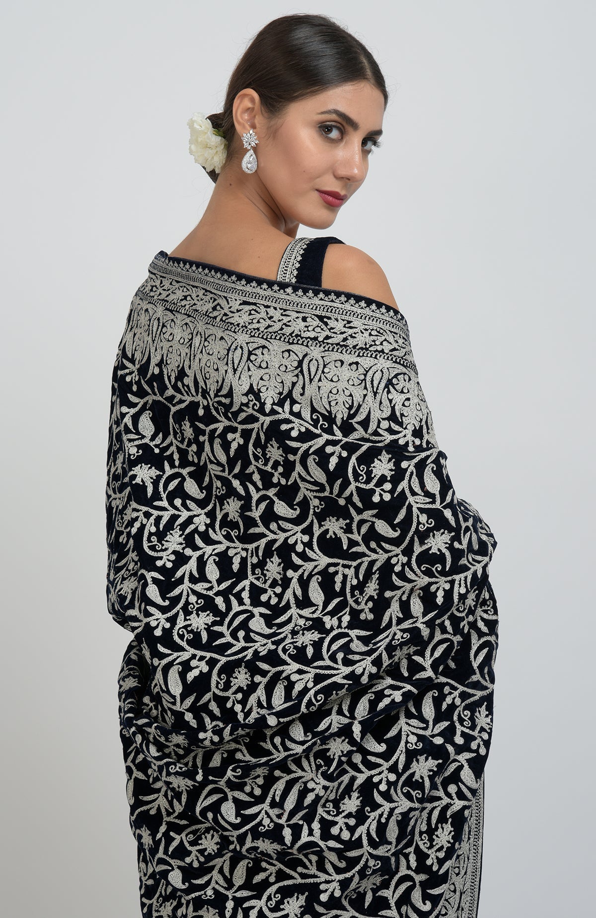 Midnight blue velvet saree with silver tilla aari embroidery, draped on a model.