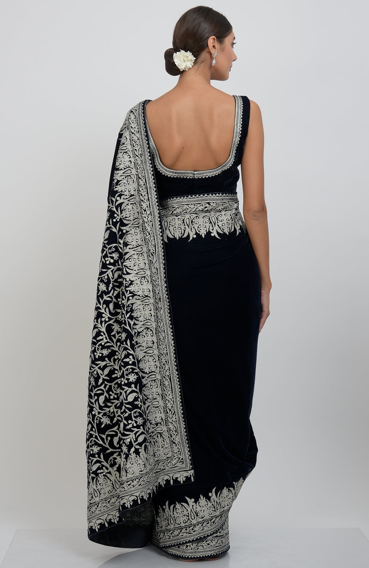 Midnight blue velvet saree with silver tilla aari embroidery, worn by a model from behind.