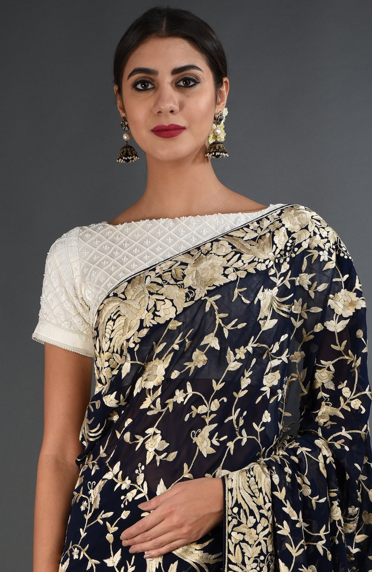 Midnight blue Parsi Gara hand embroidered saree with a white blouse.