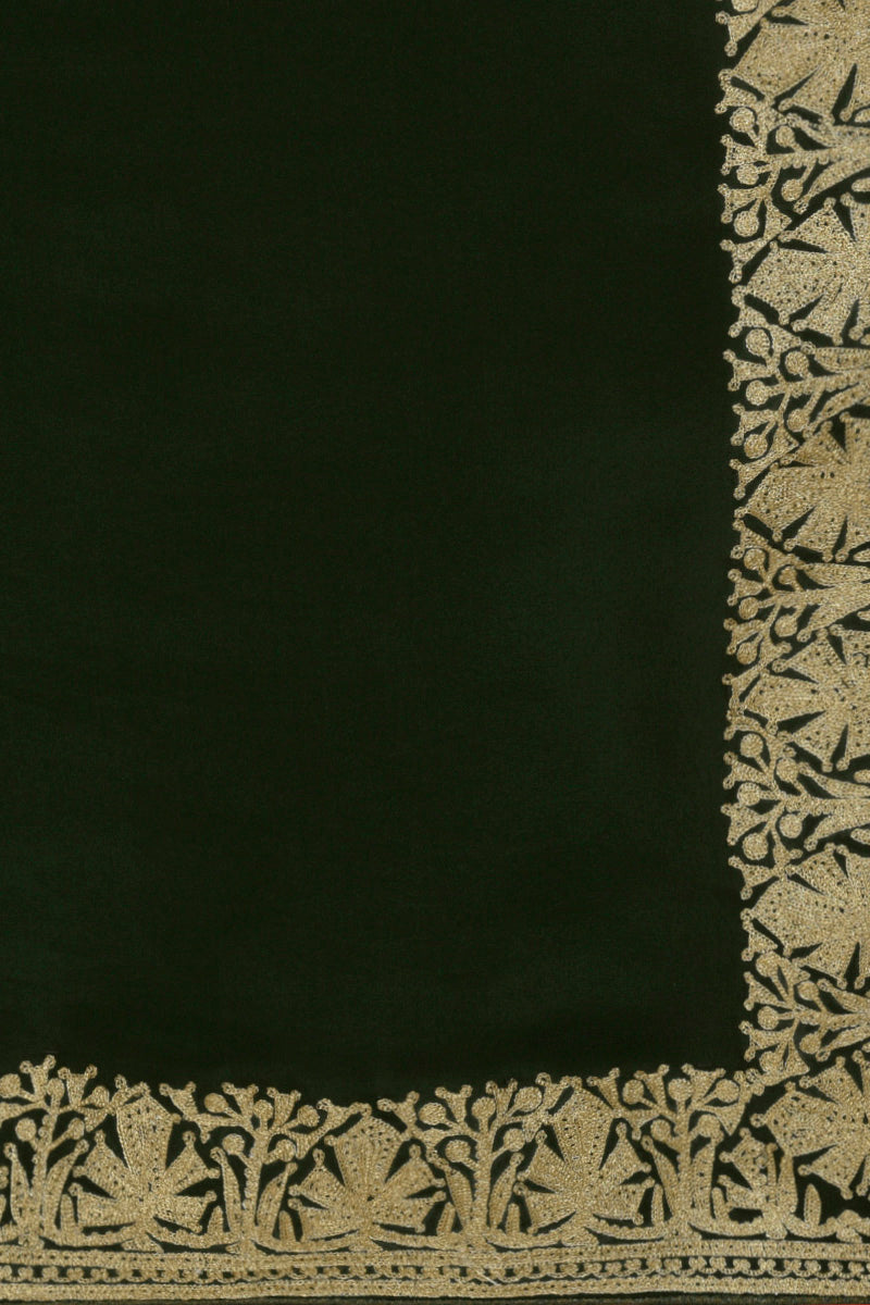 Bottle green pure crepe saree with gold tilla aari embroidered borders.