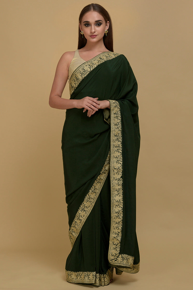 Bottle green pure crepe saree with gold Kashmiri Tilla Aari embroidery.