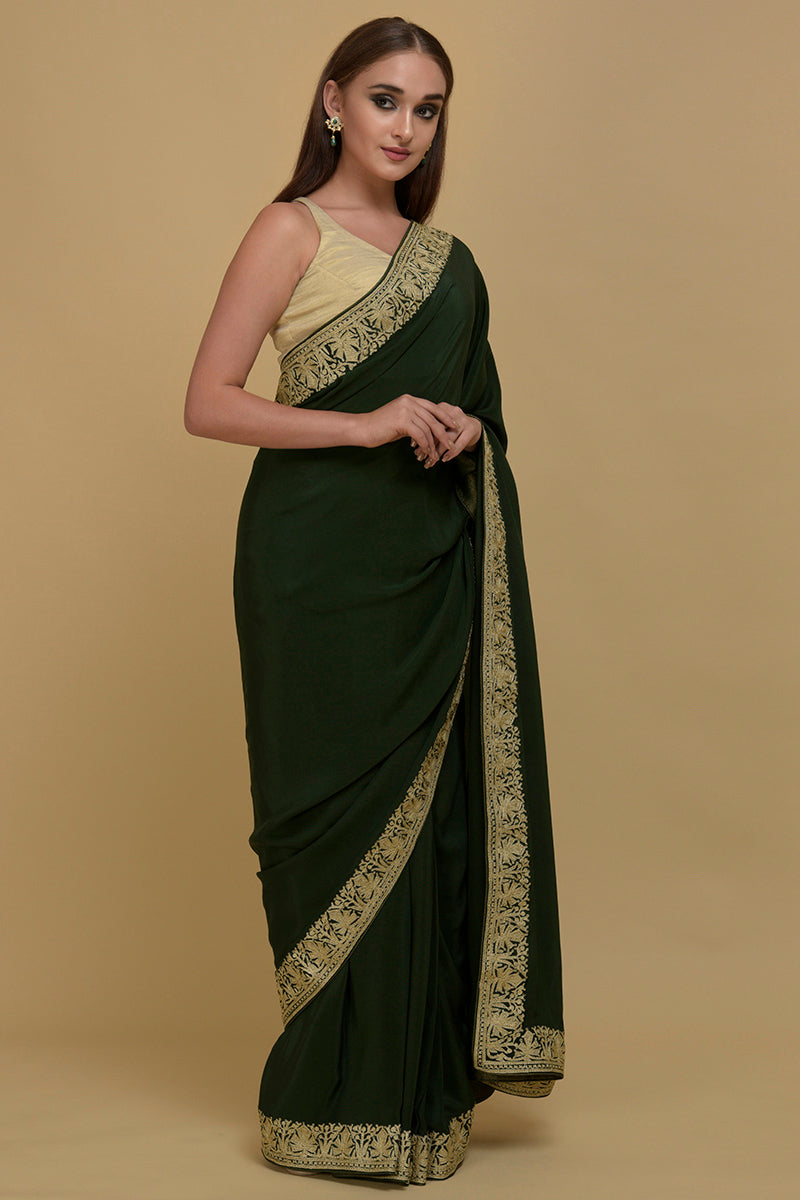 Bottle green pure crepe saree with gold Kashmiri Tilla Aari embroidery.