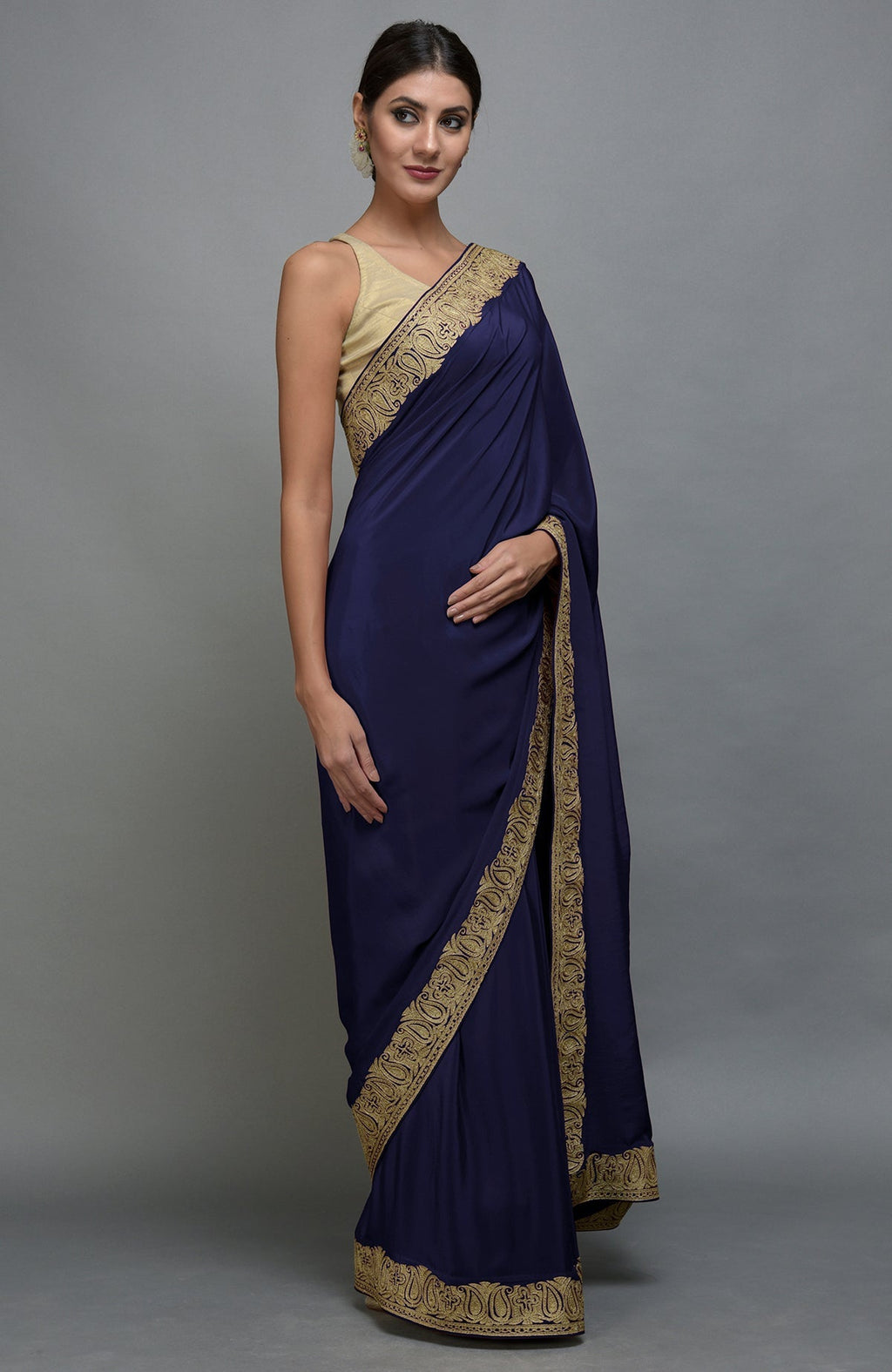 Navy blue pure crepe saree with gold paisley tilla aari embroidered borders.