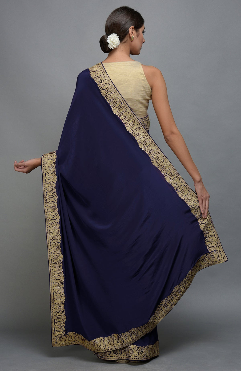 Navy blue pure crepe saree with gold paisley tilla aari embroidered borders.