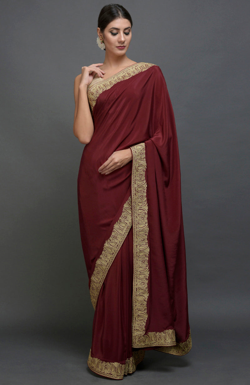 Maroon pure crepe saree with gold paisley tilla aari embroidery.