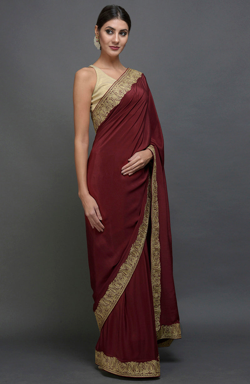 Maroon pure crepe saree with gold paisley tilla aari embroidery.