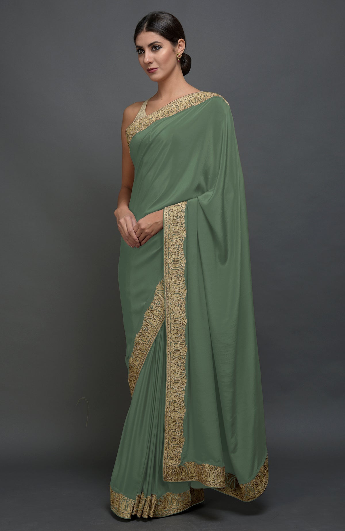 Dark jade pure crepe saree with Kashmiri tilla aari embroidered paisley borders.