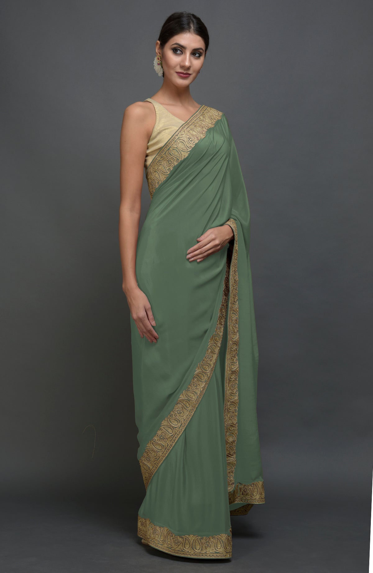 Dark jade pure crepe saree with gold paisley tilla aari embroidered borders.