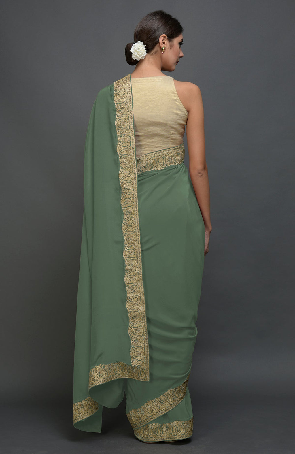 Dark jade pure crepe saree with gold paisley tilla aari embroidered borders.