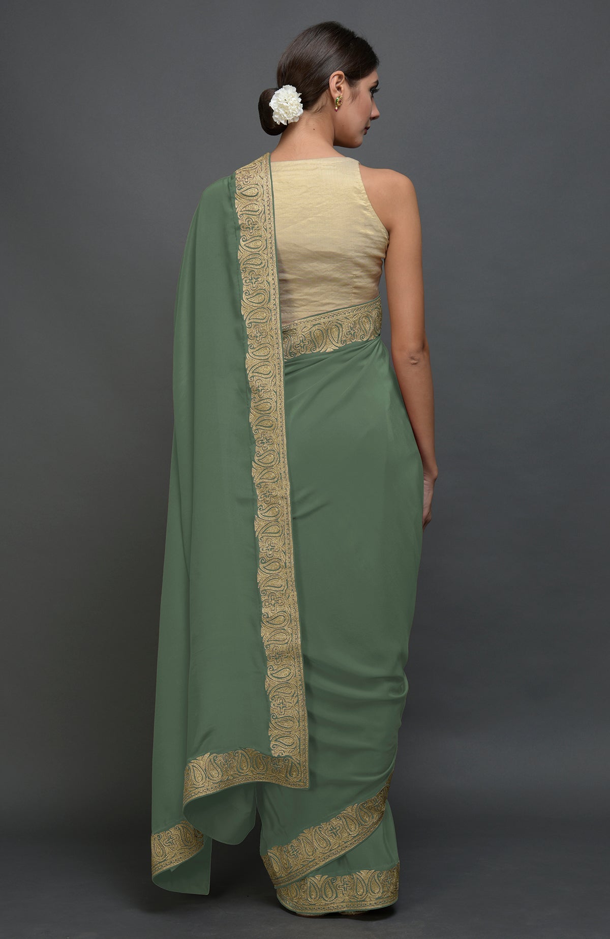 Dark jade pure crepe saree with gold paisley tilla aari embroidered borders.