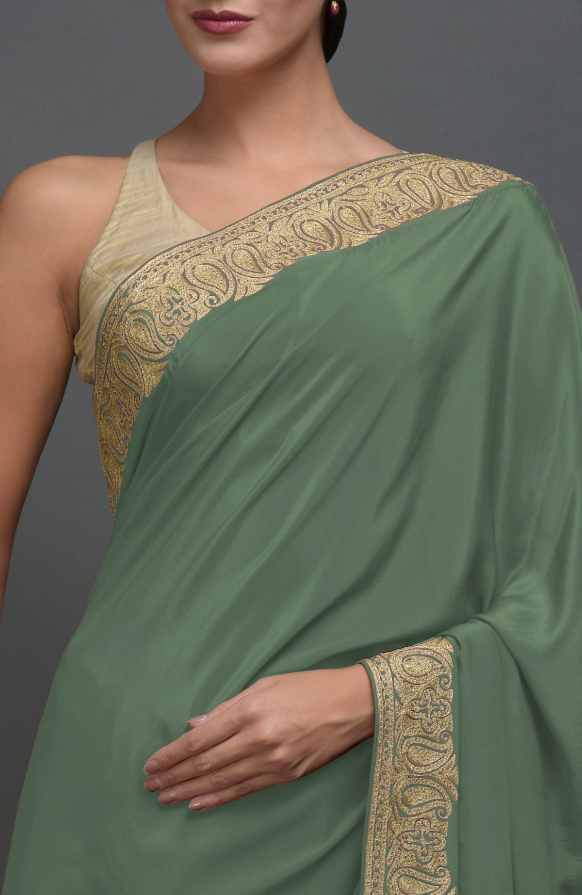Dark jade pure crepe saree with gold paisley tilla aari embroidered borders.