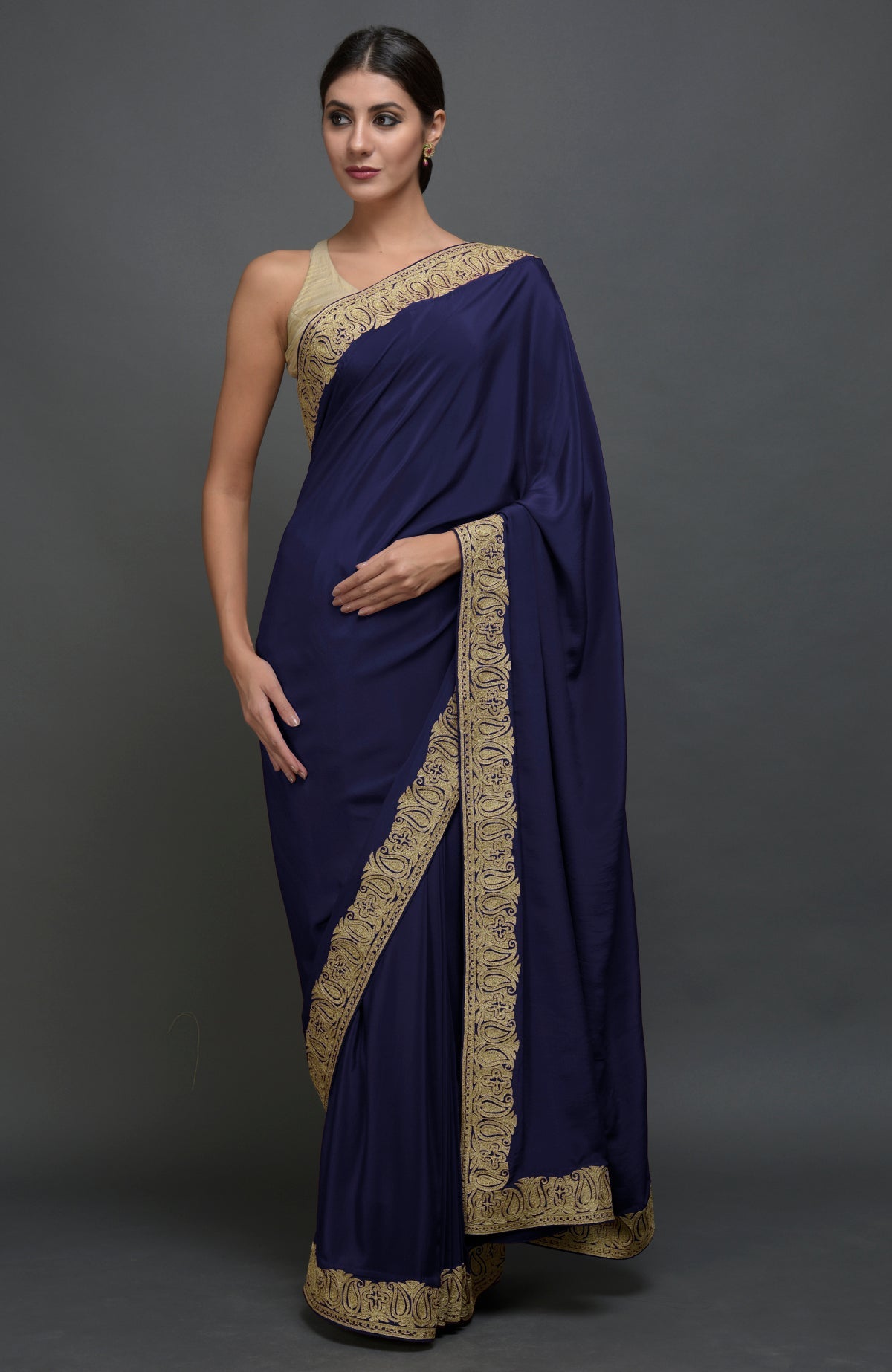 Navy blue pure crepe saree with gold paisley tilla aari embroidered borders.