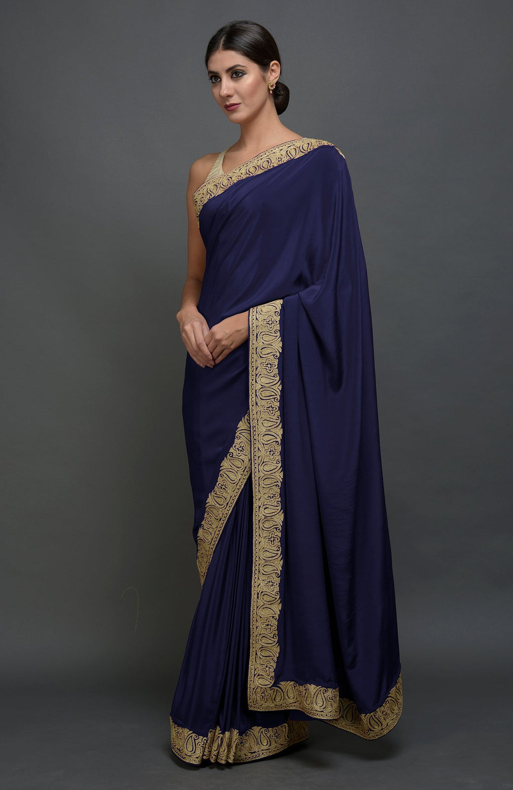 Navy blue pure crepe saree with gold paisley tilla aari embroidered borders.